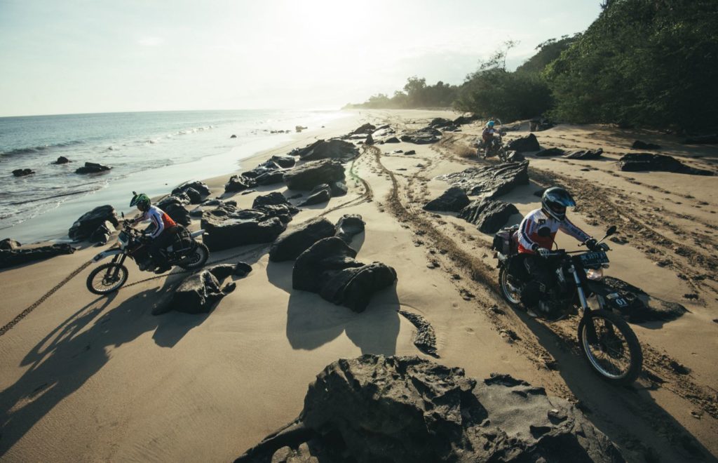 Riding along the Flores beach on our 10 day guided motorcycle tour