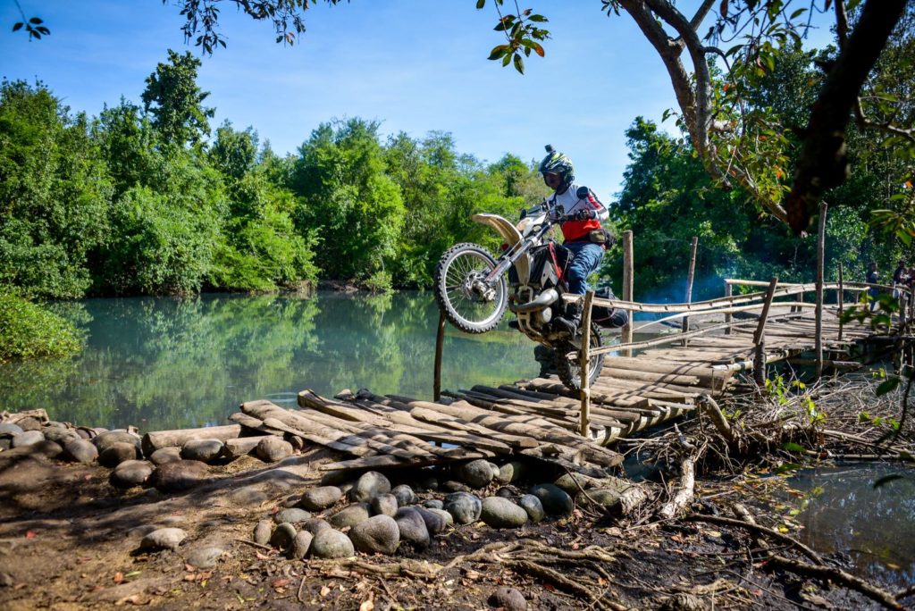Dirt Bike Wheelie across a bridge