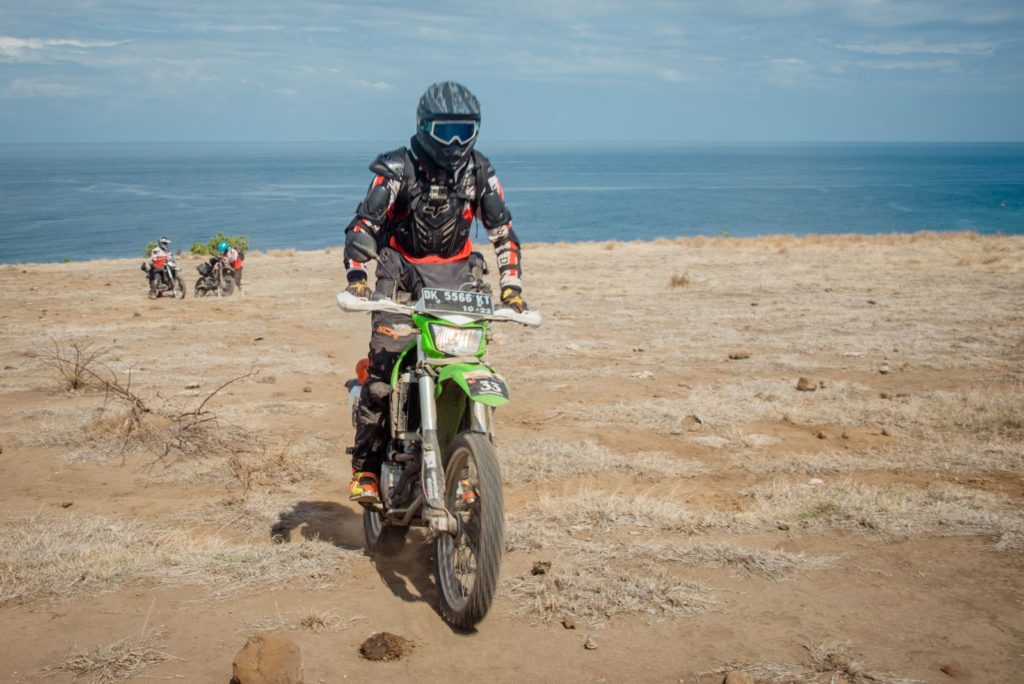 Crossing the Flores savannah on a guided dirt bike tour in Flores