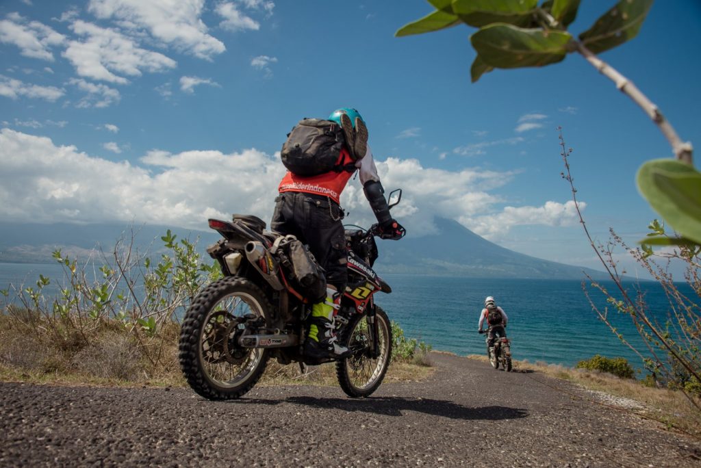 Adventure riders riding along the coast to Bajawa