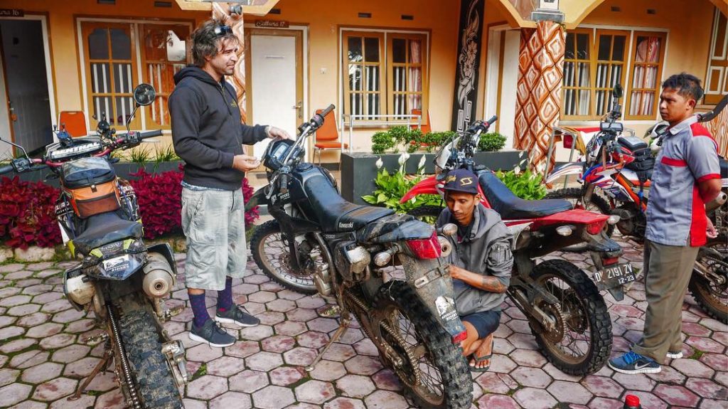Early morning dirt bike maintenance by the tour mechanic