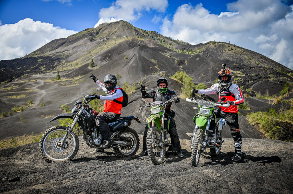 Riding the Kawasaki KLX250s in Bali while visiting the black eruption site in Kintamani